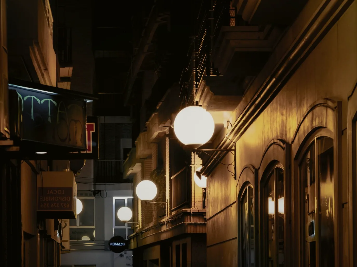 Bushland Court's sandstone frontage on Palmerin Street, lit for the evening beneath its old harness-shop cornice.